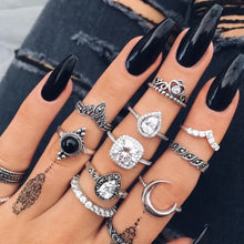 Hand with black coffin nails wearing alloy synthetic crystal 11-piece ring set