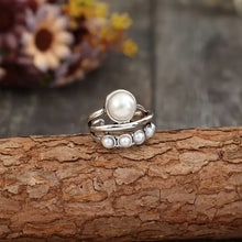 Silver alloy open ring with large central synthetic pearl and five smaller ones