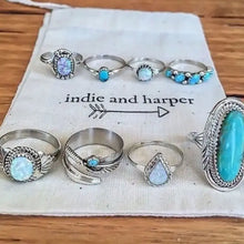 Alloy turquoise ring set with silver toned opal designs