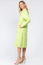 A woman wears a vibrant lime green american bazi button up distressed denim dress with long sleeves and front pockets