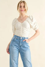 Cream-colored buttery soft ruched detailed jersey bodysuit with puff sleeves and a flattering v-neckline