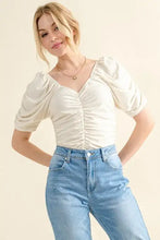 Cream-colored buttery soft ruched detailed jersey blouse with puffed short sleeves in a bodysuit style
