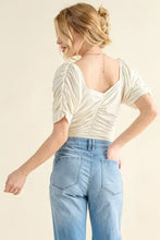 Cream-colored buttery soft ruched short-sleeve bodysuit with square neckline and back detail in soft ruched detailed jersey