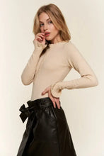 Beige knit half button round neck long sleeve bodysuit with ribbed cuffs and subtle front zipper detail