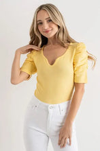 Yellow short-sleeved sleeve bodysuit with shirring puff sleeves and v-neckline in lightweight fabric