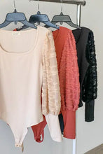Beige ribbed puff sleeve bodysuit with square neckline lace sleeves and an asymmetrical hemline textured puff design