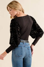 Black lace textured puff sleeve bodysuit featuring voluminous textured puff sleeves for elegant wear