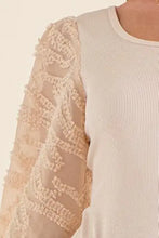 Cream-colored puff sleeve bodysuit with ribbed knit body and sheer textured lace sleeves from and the why textured puff sleeve collection