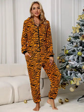 Orange and black tiger-striped plush onesie pajamas with zip front and long sleeve length lounge jumpsuit with pockets