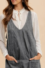 Gray denim annie wear overall dress with adjustable strap and front pockets featuring a relaxed fit design