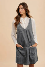 Annie Wear gray adjustable strap denim overall dress with front pockets worn over a white lace-trimmed blouse