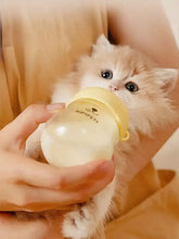 Yellow anti-choking pet nursing bottle with silicone nipple and clear glass body