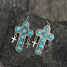Silver-toned artificial turquoise cross earrings with dangling charms