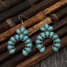 Pair of silver-tone hoop earrings with artificial turquoise teardrop stones