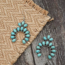 Pair of artificial turquoise squash blossom drop earrings