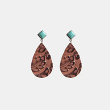 Artificial turquoise teardrop earrings with copper-toned embossed pendants
