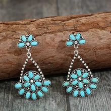 Two artificial turquoise teardrop earrings with silver dangle floral clusters