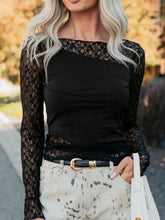 Black lace long sleeve top with solid black bodice and sheer floral lace asymmetric panels patchwork design