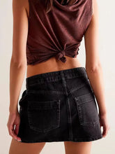 Black denim skirt with asymmetrical button front and back pockets in slightly faded finish machine wash care instructions