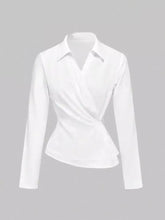 A sleek white asymmetrical button long sleeve blouse with classic collar made of smooth glossy fabric