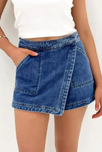 Asymmetrical denim skort with blue overlapping front panel and pockets