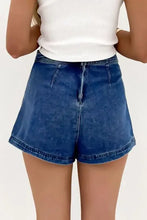 Asymmetrical denim skort with high-waist blue shorts and flared legs