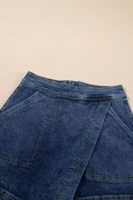 Asymmetrical denim skort with high waist, pockets, and button fly