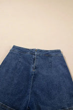 Asymmetrical denim skort with high waist, button fly, and pockets
