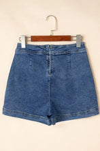 Asymmetrical denim skort with high waist, rolled hem, and wooden hanger