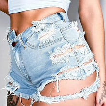 Asymmetrical distressed denim shorts with light wash and large cutouts