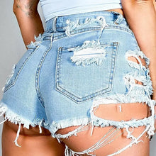 Asymmetrical distressed denim shorts with light wash and frayed hems