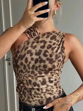 A fitted one-shoulder leopard bodysuit in shades of brown and tan with an asymmetrical neckline