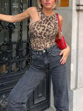 Red shoulder bag with silver chain strap complementing asymmetrical neck leopard bodysuit for stylish wear