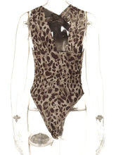 A sleek leopard bodysuit with asymmetrical neck, deep v-neckline, ruched detailing, and form-fitting design