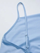 Light blue satin cami with asymmetrical neckline thin straps and delicate adjustable closure