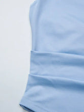 A soft light blue satin cami with asymmetrical neckline and ruched detail in smooth textured fabric