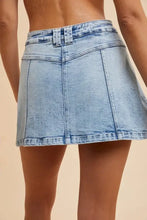 Light blue asymmetrical stretch denim wrap mini skort with flattering silhouette