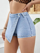 Light-wash asymmetrical studded denim shorts with pearl overlay