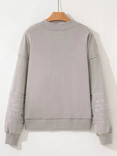 Gray western v neck sweatshirt with subtle white embroidered aztec tribal patterns along cuffs machine wash cold