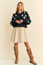 Dani floral pattern black star sweater with white green accents