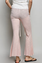 Pink bell-bottom ribbed knit pants with textured fabric and subtle side ties from pol drawstring collection