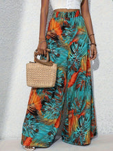 Vibrant tropical print wide leg pants featuring teal orange and black leaf pattern perfect for casual wear