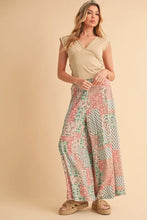 Aemi+Co printed wide leg pants feature soft pink mint green and beige floral patchwork with a flowing relaxed fit