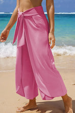 Pink knotted waist split leg relaxed pants with wide-leg design and tied waistband for casual comfort