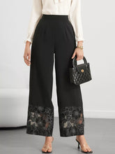 Black wide-leg trousers with intricate floral lace hem detailing at the cuffs featuring a lace hem wide design