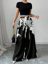 Black and white floral print wide leg pants made from lightweight fabric for stylish comfortable wear