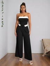 Black and white strapless jumpsuit with wide leg pants and a contrasting white belt featuring wide-leg pants design