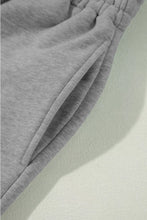 Gray heathered drawstring loose fit pants made of soft textured fabric with elastic waistband for comfortable wear