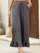 Gray wide leg sweatpants with drawstring waist and ruffled hem designed as ruffled wide leg pull on high waist pants with pockets