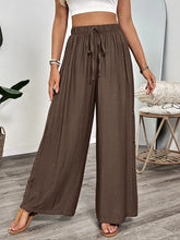 Brown casual wide-leg pants with elastic waistband and drawstring offering comfortable fit and easy care instructions
